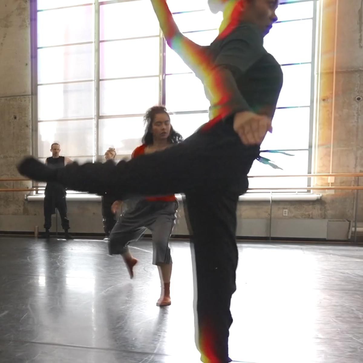 Dancers in a studio backlit by sunlight