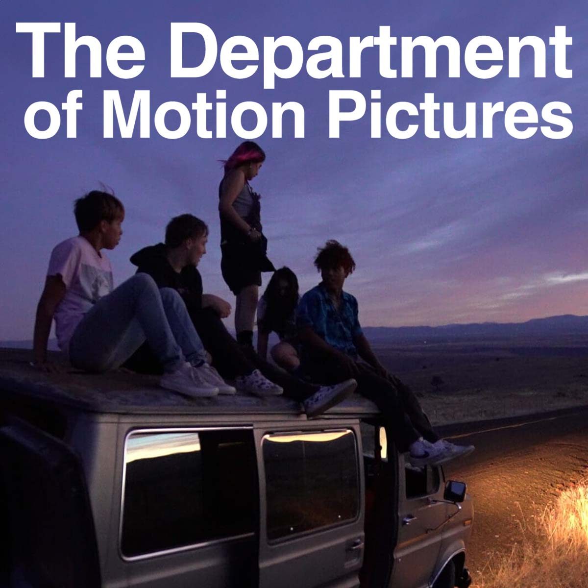 Young people sitting on top of an SEO looking out at a purple sky